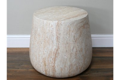Rounded stone-effect side table with a smooth sculptural shape and travertine-style finish in warm natural tones.