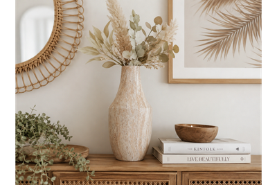 Stone-effect decorative vase with a curved silhouette and textured travertine-style finish in warm natural tones.