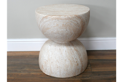 Cream stone-effect side table with a sculptural hourglass shape and subtle natural marbling.