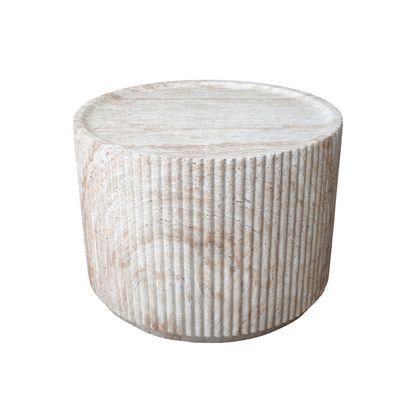 Round stone-effect coffee table with ribbed detailing, natural textured finish and a contemporary sculptural design.