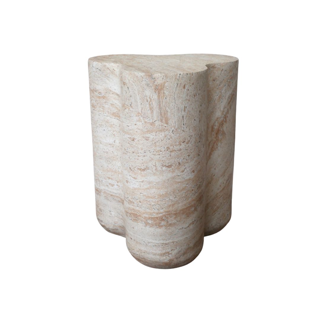 Travertine-effect side table with sculptural pillar base and organic shape in warm cream and natural stone tones.