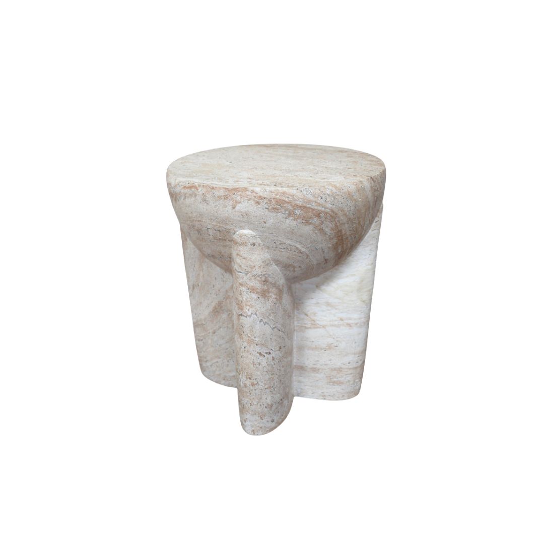 Sculptural stone-effect side table with curved pillar legs and a travertine-style finish in soft natural cream tones.