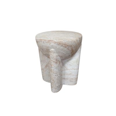 Sculptural stone-effect side table with curved pillar legs and a travertine-style finish in soft natural cream tones.