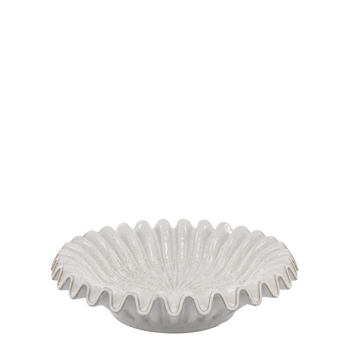 Large white ceramic shell bowl with scalloped edges, filled with seashells and displayed on a wooden coffee table.