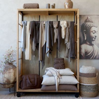 Industrial-style open wardrobe with natural wood frame, hanging rail, side shelving and castors for flexible bedroom storage.