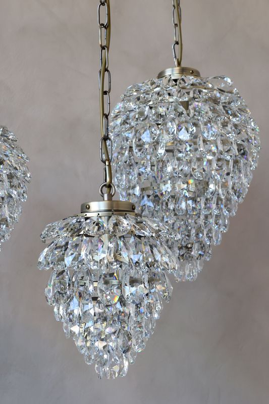 Droplet glass prism chandelier with cascading crystal-effect pendants, creating sparkling elegance and timeless luxury.