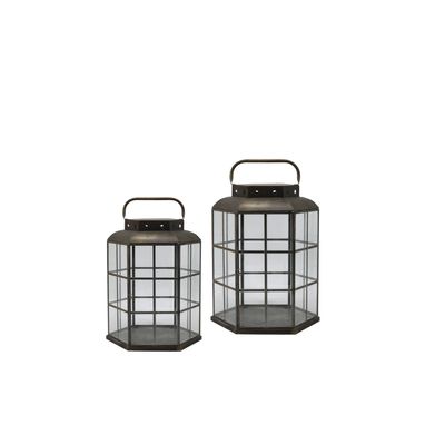 Set of two hexagonal metal and glass lanterns in antique bronze finish with carry handles, shown in small and large sizes.