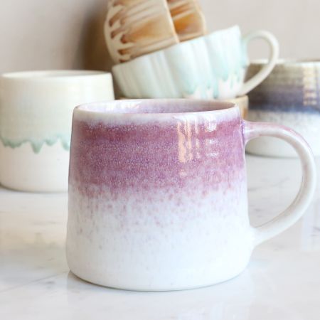 Heather Blush: Ceramic mug with a softly rounded shape, curved handle and reactive dusky-mauve glaze fading into speckled.
