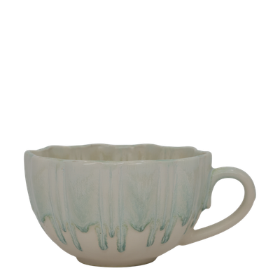 Slow Morning Cup in Seafoam Milk, featuring a cream ceramic base, soft pale-aqua dripping glaze, ribbed texture,.