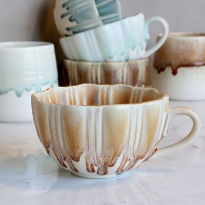 Slow Morning Cup in Buttermilk Swirl, with warm cream glaze, ribbed sides, uneven rim and rounded handle.