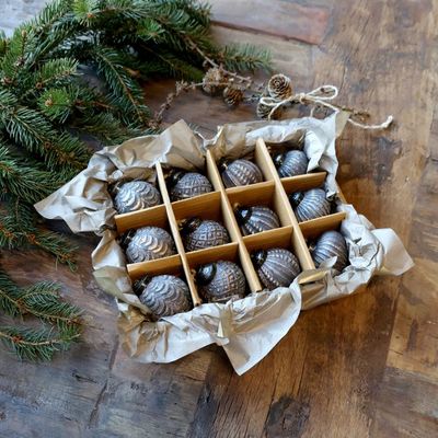 Boxed set of twelve dark mocca baubles with assorted embossed patterns and distressed antique-style metallic detailing.