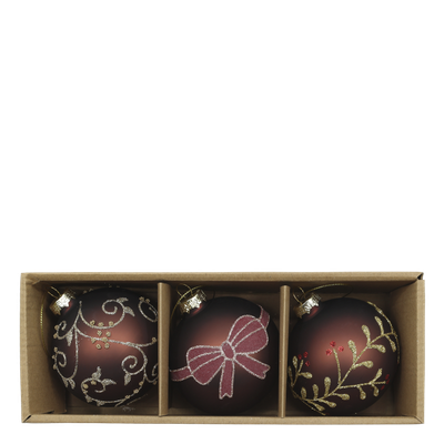 Mocha Winter Keepsake Christmas Baubles – Set of Three Three mocha Christmas baubles decorated with glittering bows, botanical sprigs and scrolls, arranged among evergreen foliage.
