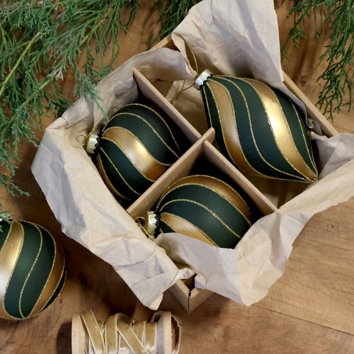 Boxed set of three dark green Christmas baubles in assorted shapes, decorated with sweeping gold and glitter swirls.

