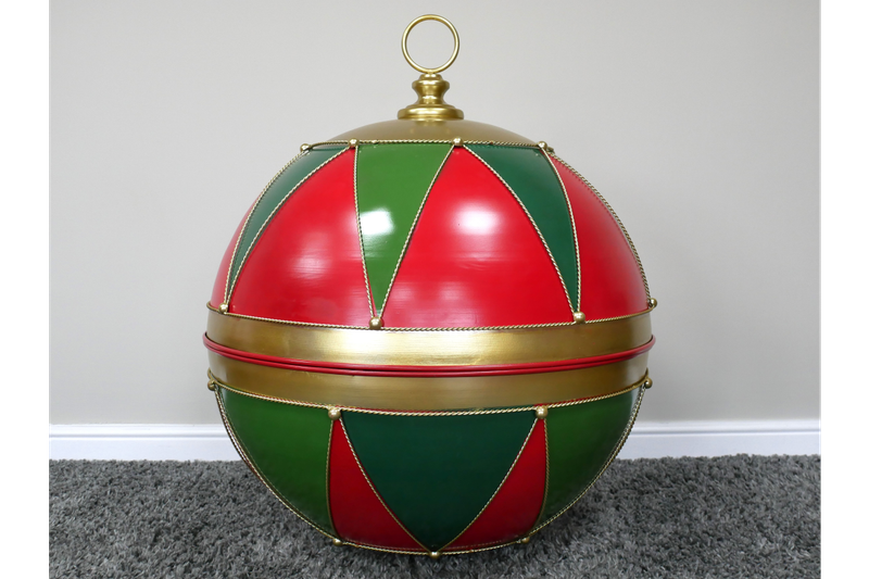 Oversized red and green harlequin Christmas display bauble with gold-toned edging, a broad centre band and top ring.