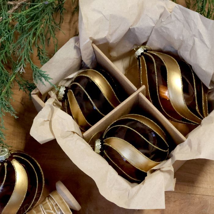 Three glossy mocca Christmas baubles in assorted shapes, decorated with sweeping gold ribbons and fine glitter edging.
