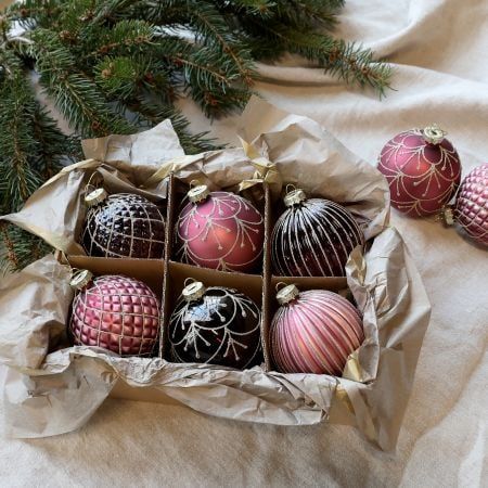 Six rose pink and mulberry Christmas baubles with assorted striped, quilted and botanical metallic patterns.

