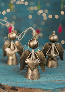 Three bronze-toned recycled iron angel decorations with outstretched wings, holding a heart, bird or star.