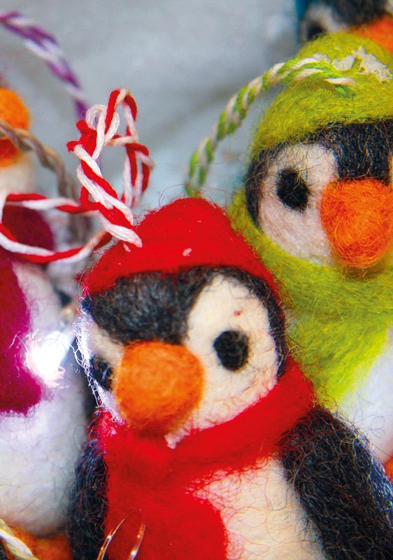 Six handmade felt penguin decorations wearing colourful scarves, shown together to illustrate the available colour choices.