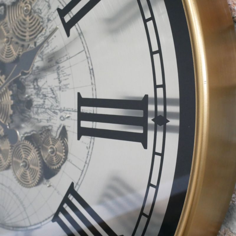 Extra-large round clock with an antique-brass frame, Roman numerals, a world map and decorative central cogs.