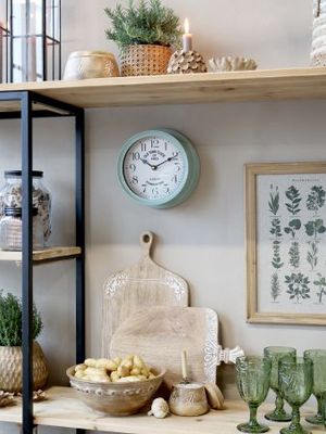 Round blue-grey wall clock with a white face, black numerals, vintage lettering and black hands.
