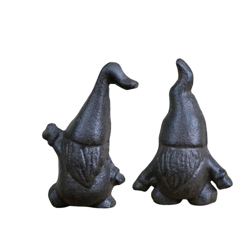 Two small black cast iron garden gnomes with pointed hats, round noses and textured beards.