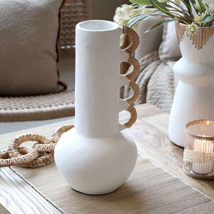 A sculptural white vase with woven loop details, bringing natural texture and understated character to any room.