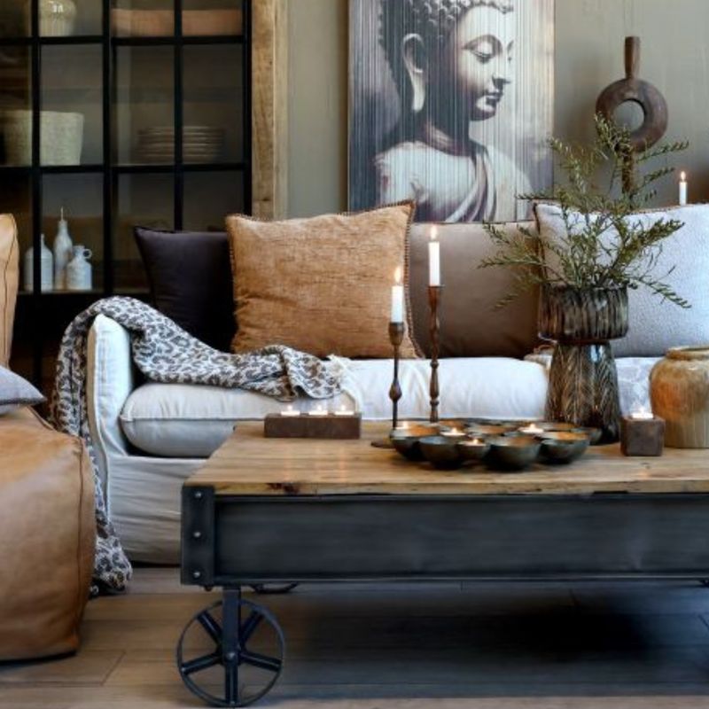 Industrial trolley coffee table with a timber top, dark metal frame and four iron wheels.