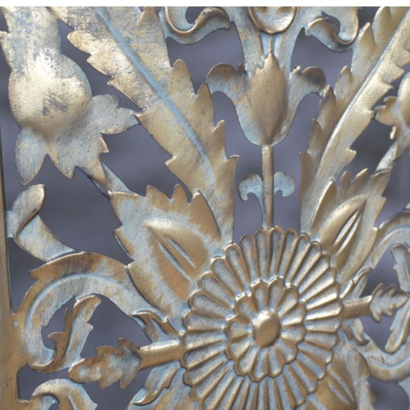 Three-panel gold metal room divider with intricate floral cut-out detailing and an elegant vintage-inspired finish.