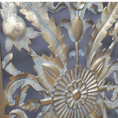 Three-panel gold metal room divider with intricate floral cut-out detailing and an elegant vintage-inspired finish.
