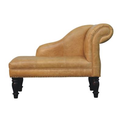 Gracefully curved tan leather chaise with traditional stud detailing, turned wooden legs and timeless country-house charm.