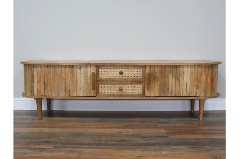 Low wooden TV cabinet with curved ends, fluted doors, two cane-fronted drawers and tapered legs.