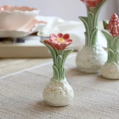 Ceramic Botanical Coral Bloom ornament with textured cream bulb, green leaves and a coral-red flower with yellow centre.