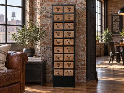 Tall black and natural wood storage cabinet with multiple small drawers, metal label holders and circular drawer pulls.