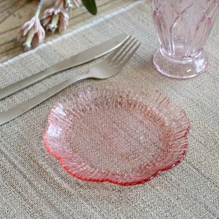 Blush pink glass flower bowl with softly scalloped edges, intricate rippled texture and a smooth, rounded centre.