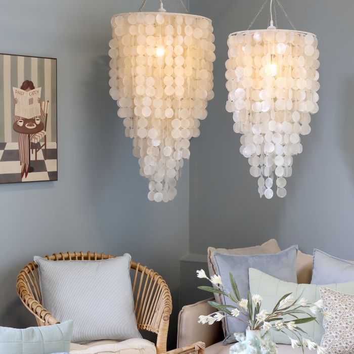 Pearl white seashell chandelier with cascading circular shell discs, tapered silhouette and natural rope suspension.