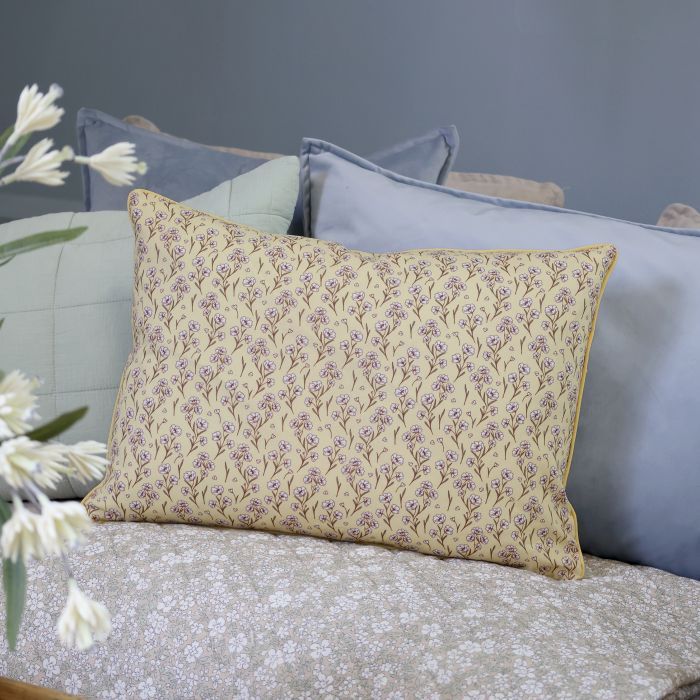 Rectangular melon yellow cushion with delicate mocca floral stems, tiny ivory blossoms and matching piped edges.