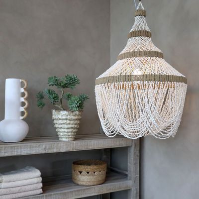 Ivory seashell and pearl tiered chandelier with iron frame, natural bands, intricate detailing and scalloped strands.