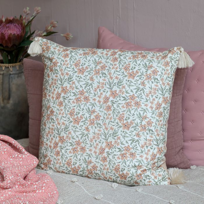 Square ivory cushion with delicate taupe flowers, sage green foliage and decorative cream tassels at each corner.