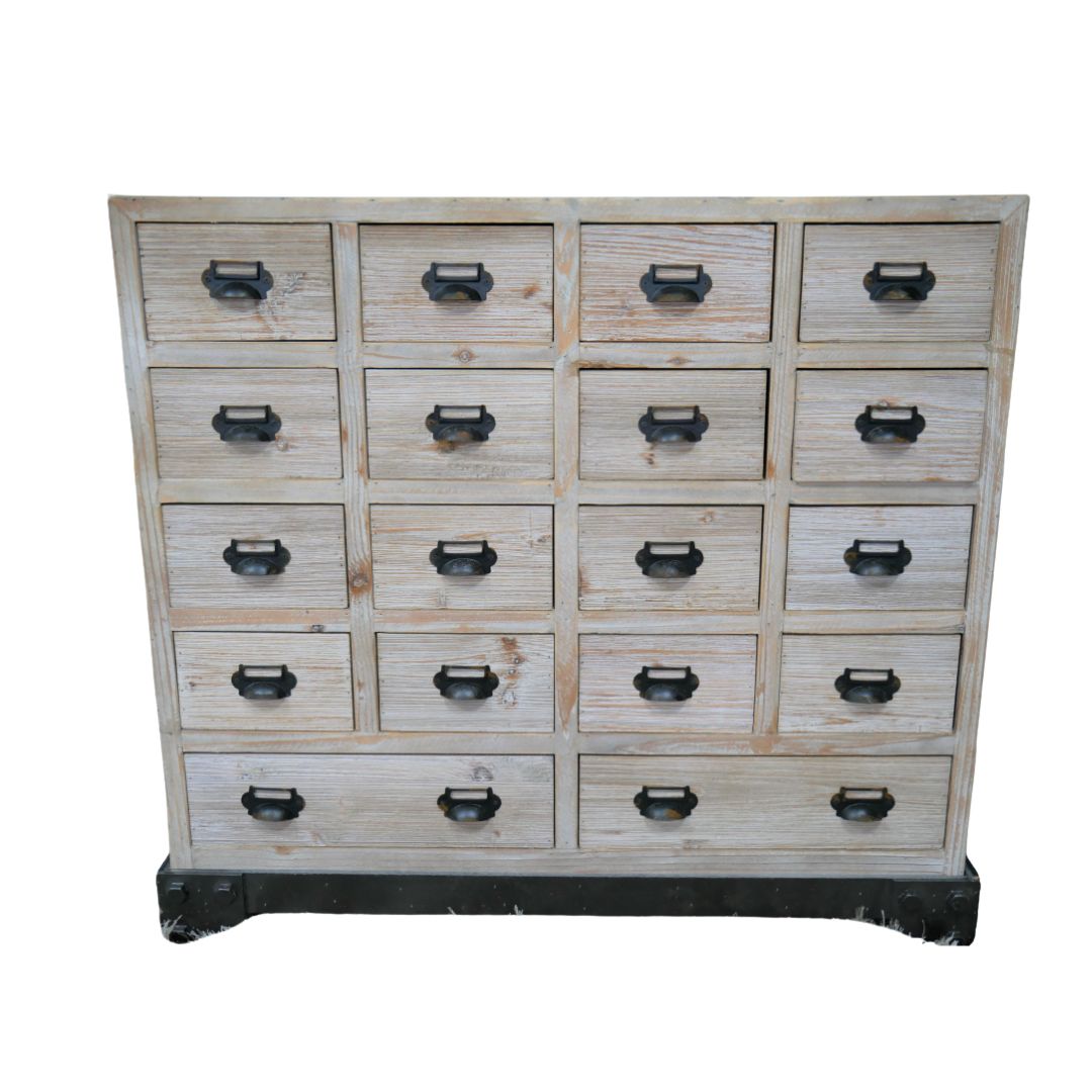 The Atelier reclaimed wood cabinet with sixteen drawers, distressed pale timber finish and dark metal label-holder handles.