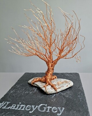 Small copper wire tree (~30cm tall) on Connemara beach stone
