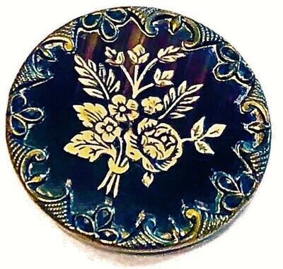 A LARGE TINTED IVOROID FLORAL BUTTON