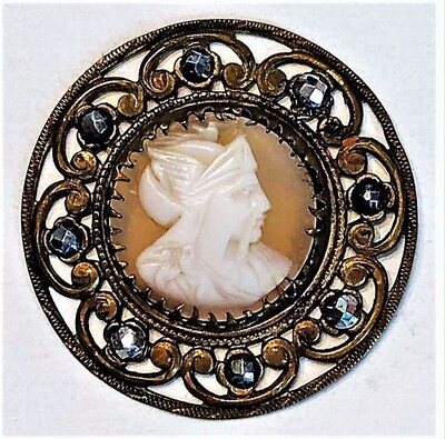A LARGE OPENWORK SETTING WITH A CAMEO SHELL CENTER