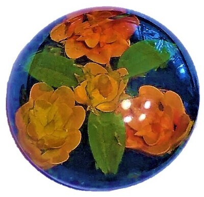 A LARGE REVERSE PAINTED AND CARVED BAKELITE FLORAL