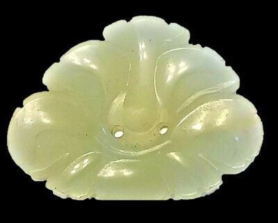 A LARGE LOW RELIEF CARVED JADE BUTTON