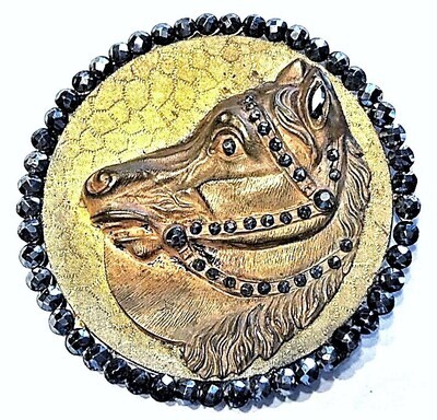 AN EXTRA LARGE BRASS AND CUT STEEL HORSE BUTTON