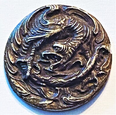 AN EXTRA LARGE MOLDED DRAGON BUTTON