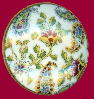 A LARGE 19TH CENTURY PAISLEY DESIGN BUTTON ON CERAMIC