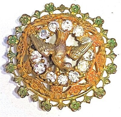 AN UNUSUAL LARGE PIERCED BRASS AND PASTE OME BIRD BUTTON
