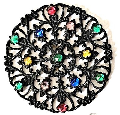 A LARGE FILIGREE TYPE BRASS AND COLORED JEWEL BUTTON