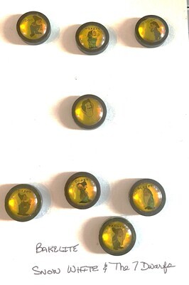 A SCARCE SET OF BAKELITE SNOW WHITE AND THE 7 DWARF BUTTONS